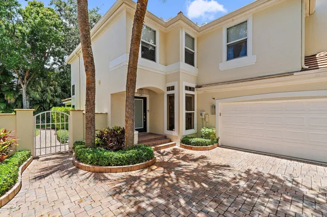 a view of a hallway with wooden floor and a living room