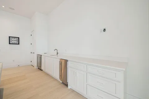 a white toilet and sink in a bathroom next to a window