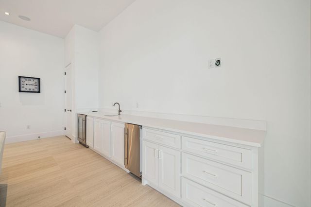 a white toilet and sink in a bathroom next to a window