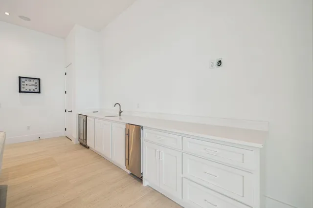 a white toilet and sink in a bathroom next to a window