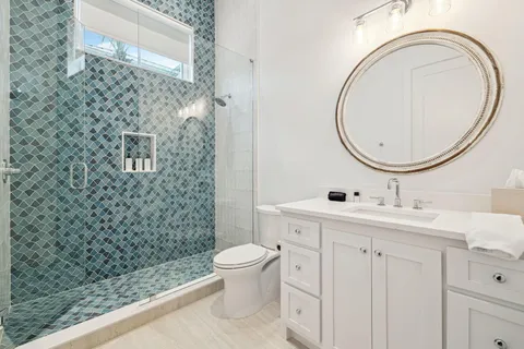 a kitchen with stainless steel appliances granite countertop a table and chairs in it