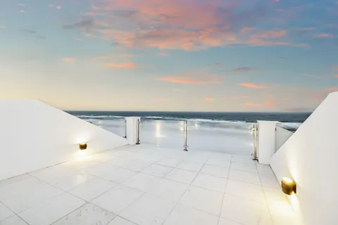 a view of a kitchen with white cabinets