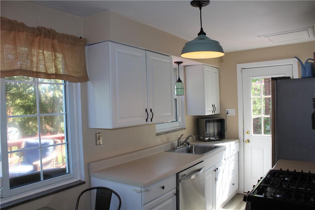 2023 Brookfield Road Pittsburgh, PA 15243 - Photo 4 of 21 a kitchen with a sink a stove and a refrigerator