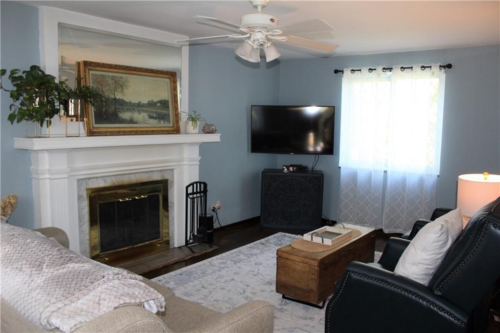 2023 Brookfield Road Pittsburgh, PA 15243 - Photo 7 of 21 a living room with furniture a flat screen tv and a fireplace