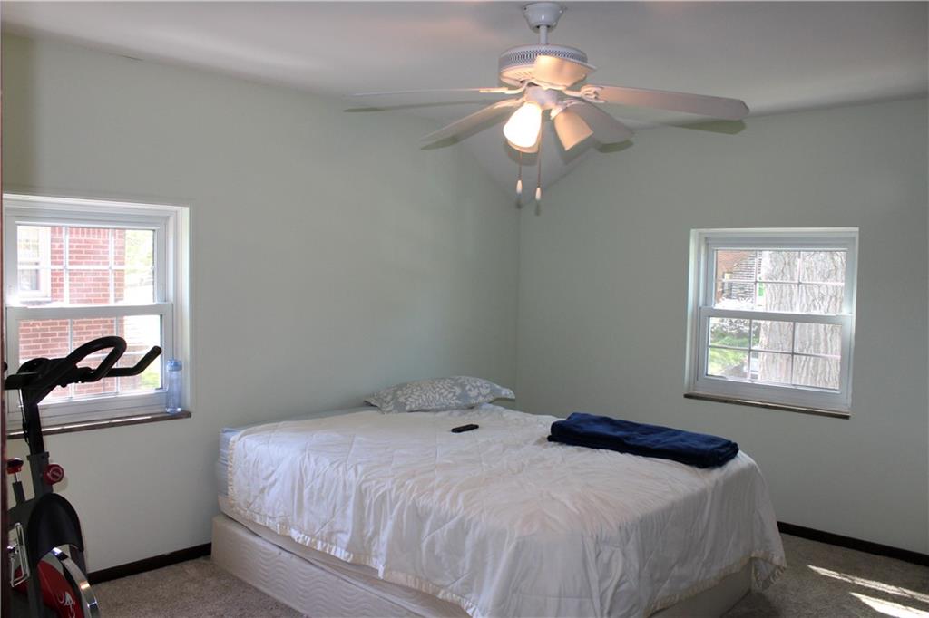 2023 Brookfield Road Pittsburgh, PA 15243 - Photo 10 of 21 a bedroom with a bed and a chandelier