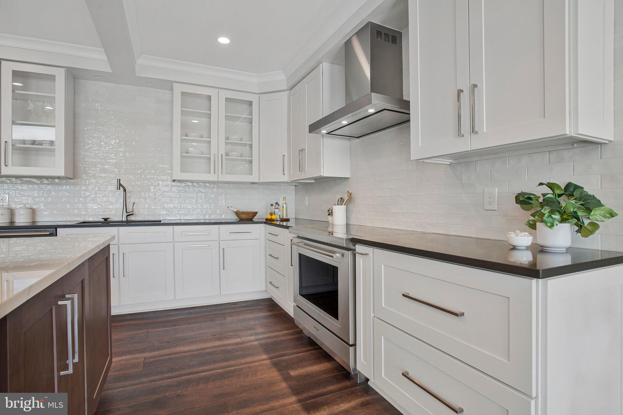 6146 Drum Point Road Deale, MD 20751 - Photo 14 of 75 a kitchen with granite countertop white cabinets stainless steel appliances and sink