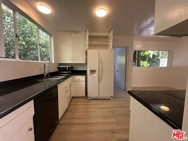 a kitchen with a refrigerator and a sink