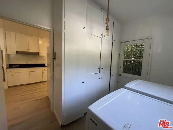 a kitchen with granite countertop a refrigerator and a stove top oven