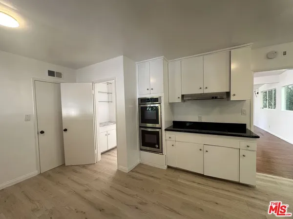 a view of a room with wooden floor and a fireplace