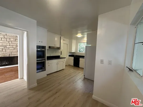 a kitchen with stainless steel appliances a refrigerator and a stove top oven