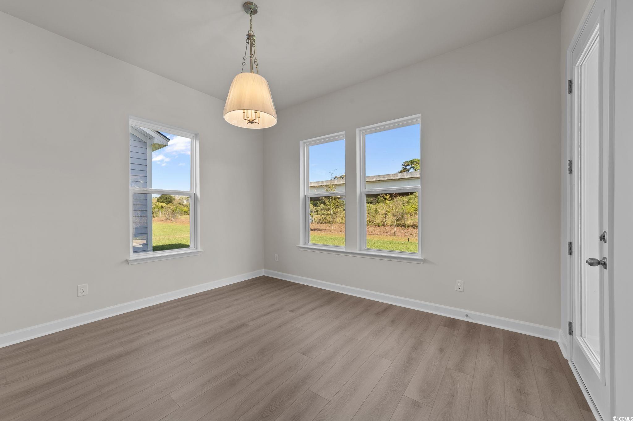 775 Ebb Tide Road Little River, SC 29566 - Photo 11 of 39 Unfurnished room with wood finished floors and baseboards
