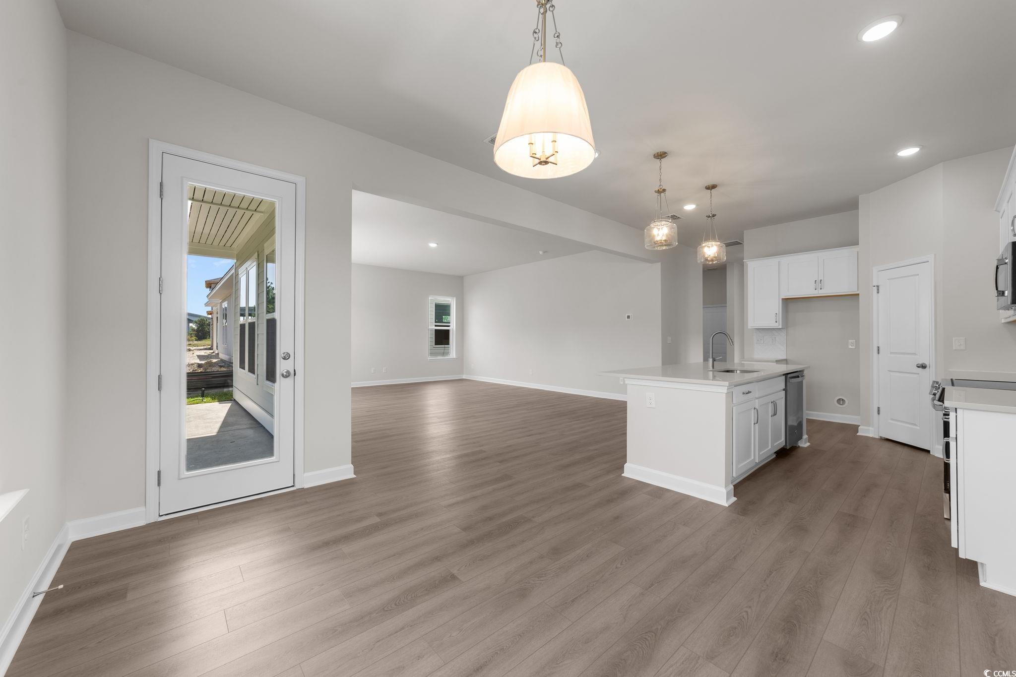 775 Ebb Tide Road Little River, SC 29566 - Photo 39 of 39 Kitchen featuring hanging light fixtures, open floor plan, a center island with sink, dark wood-type flooring, and recessed lighting