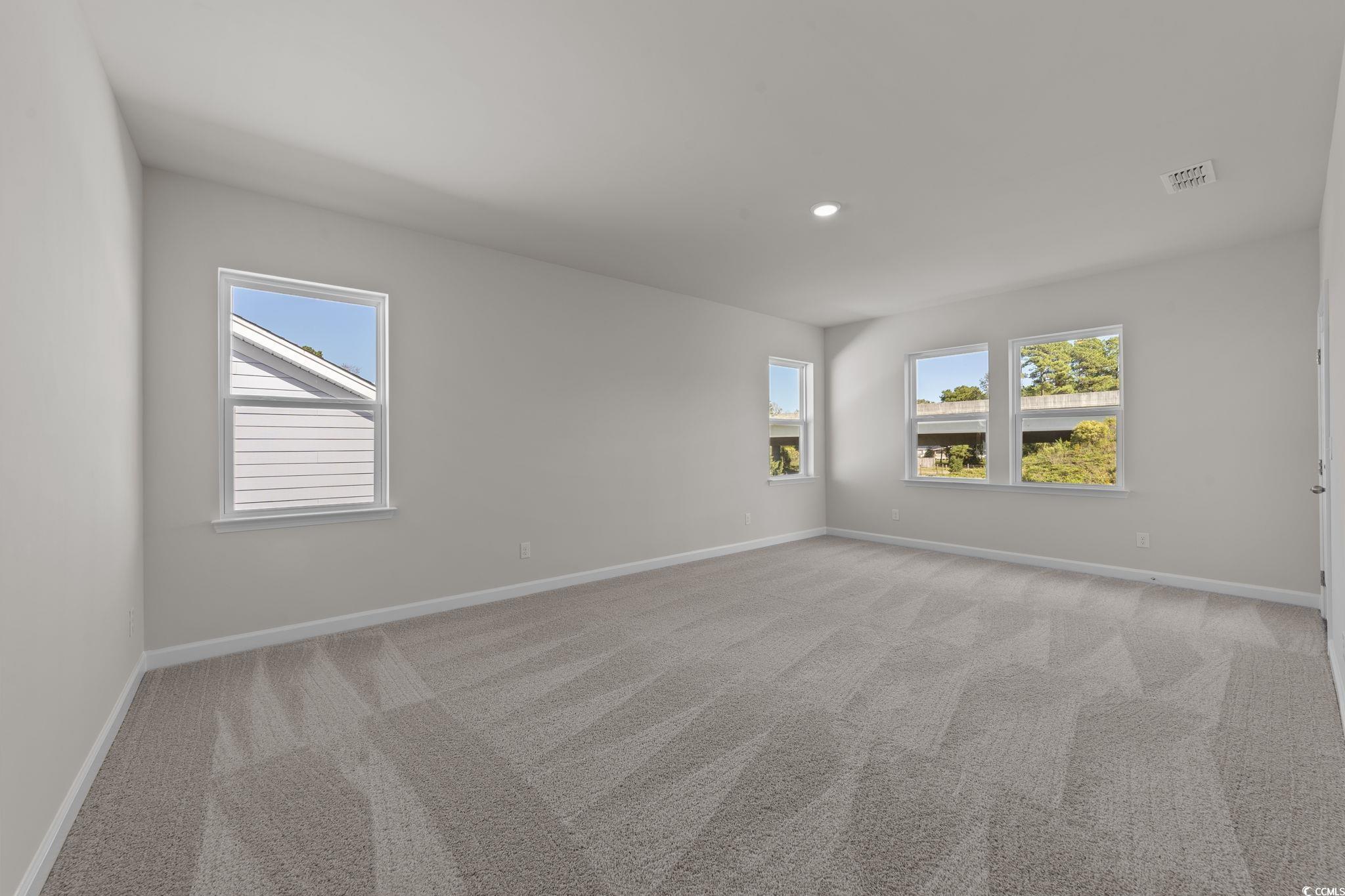 775 Ebb Tide Road Little River, SC 29566 - Photo 16 of 39 Spare room featuring light carpet, plenty of natural light, and recessed lighting