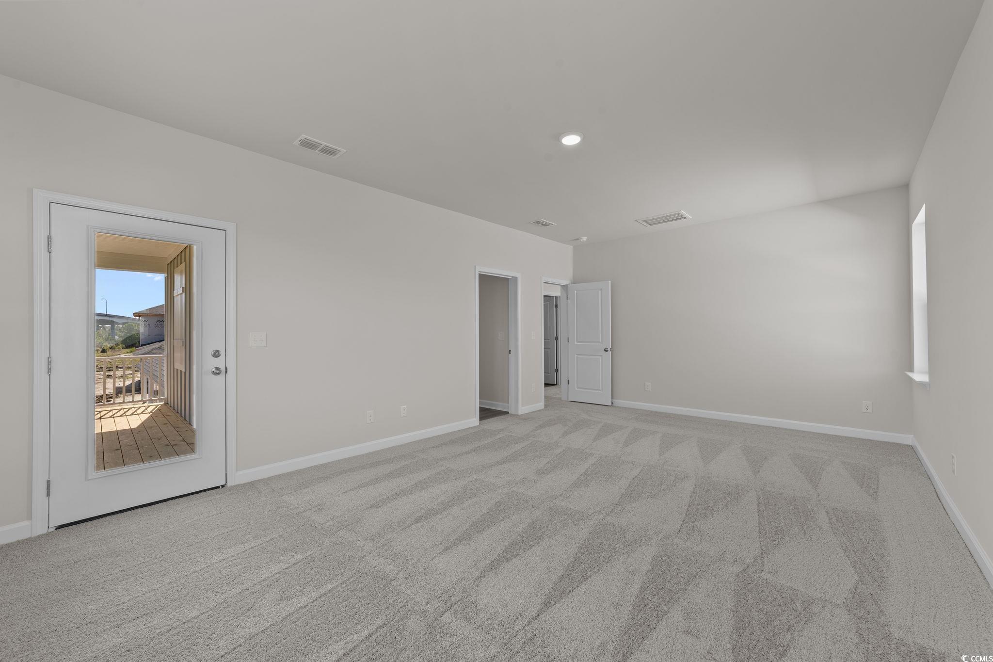 775 Ebb Tide Road Little River, SC 29566 - Photo 17 of 39 Unfurnished bedroom with light carpet and access to outside