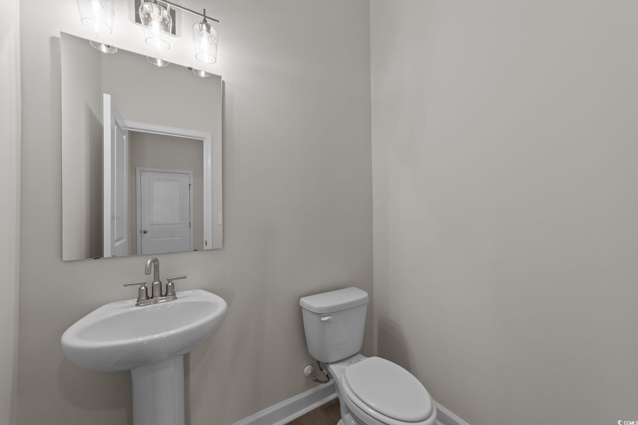 775 Ebb Tide Road Little River, SC 29566 - Photo 27 of 39 Half bathroom featuring toilet and baseboards