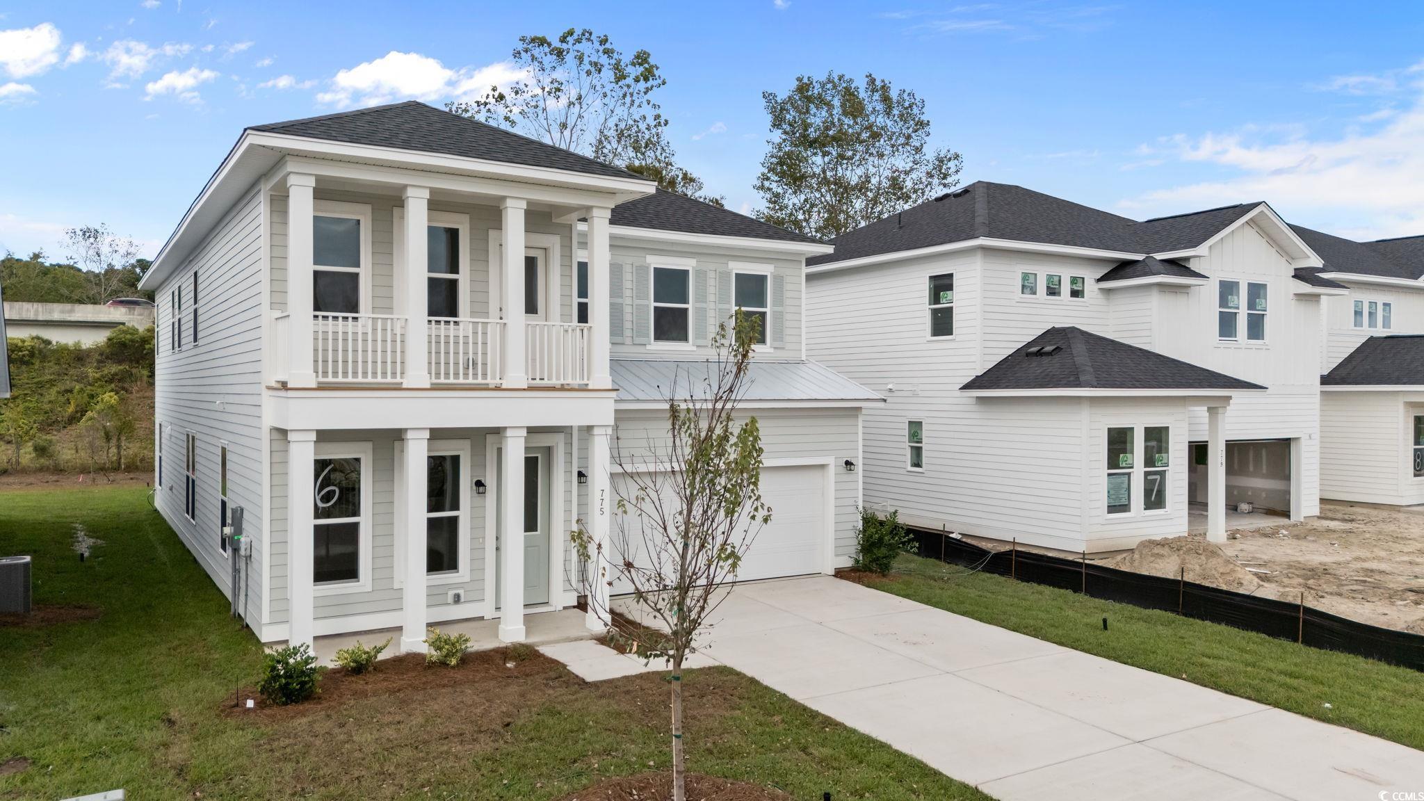 775 Ebb Tide Road Little River, SC 29566 - Photo 3 of 39 View of front of home with a shingled roof, driveway, a balcony, and covered porch