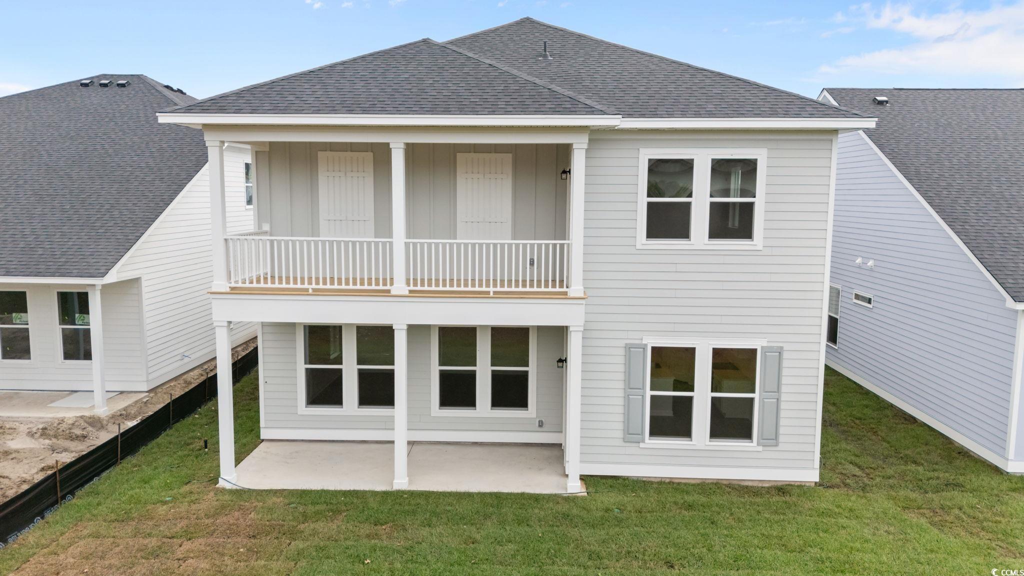 775 Ebb Tide Road Little River, SC 29566 - Photo 4 of 39 Rear view of property featuring a shingled roof, a patio, and a lawn