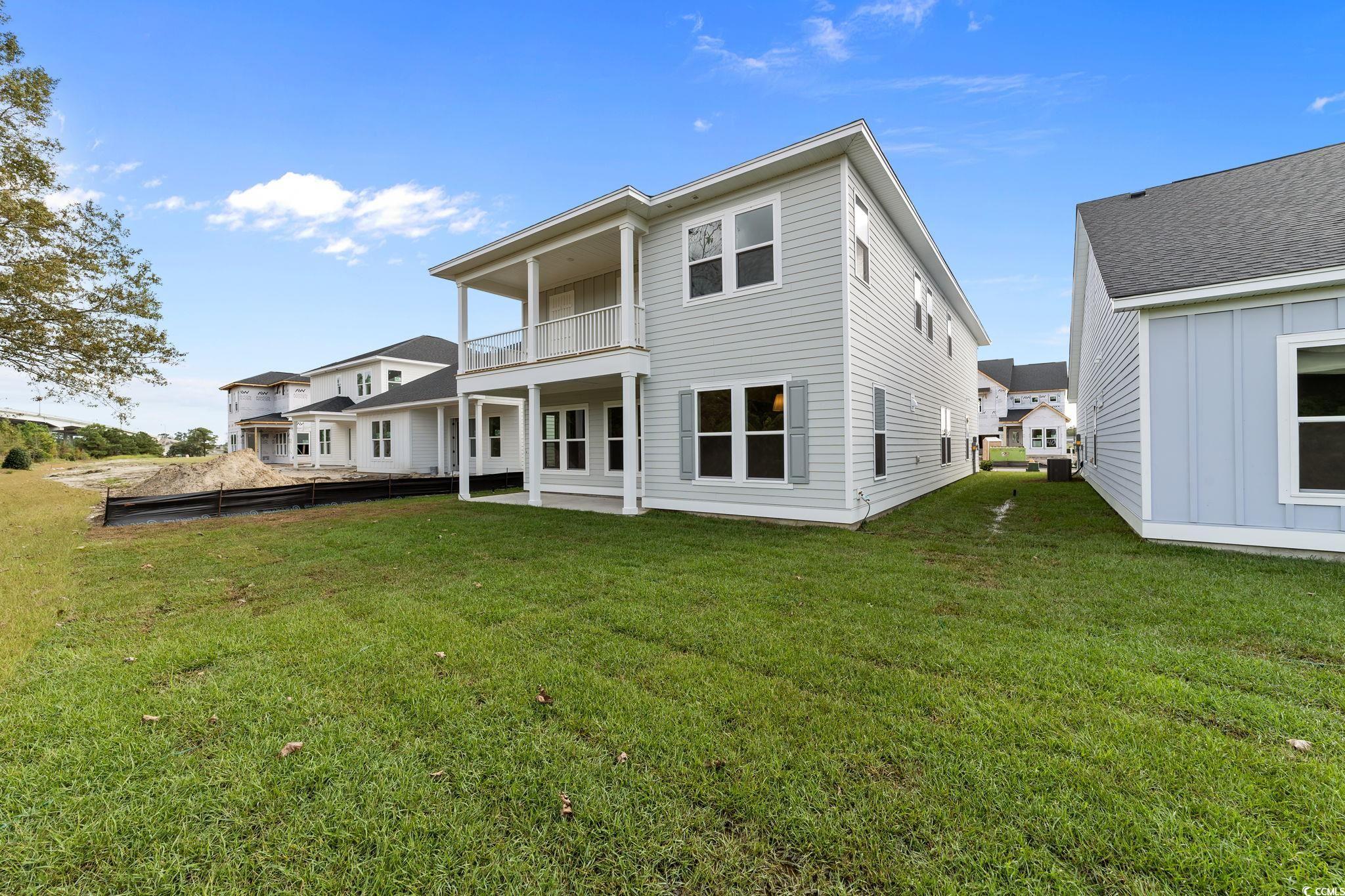 775 Ebb Tide Road Little River, SC 29566 - Photo 5 of 39 Rear view of house featuring a yard