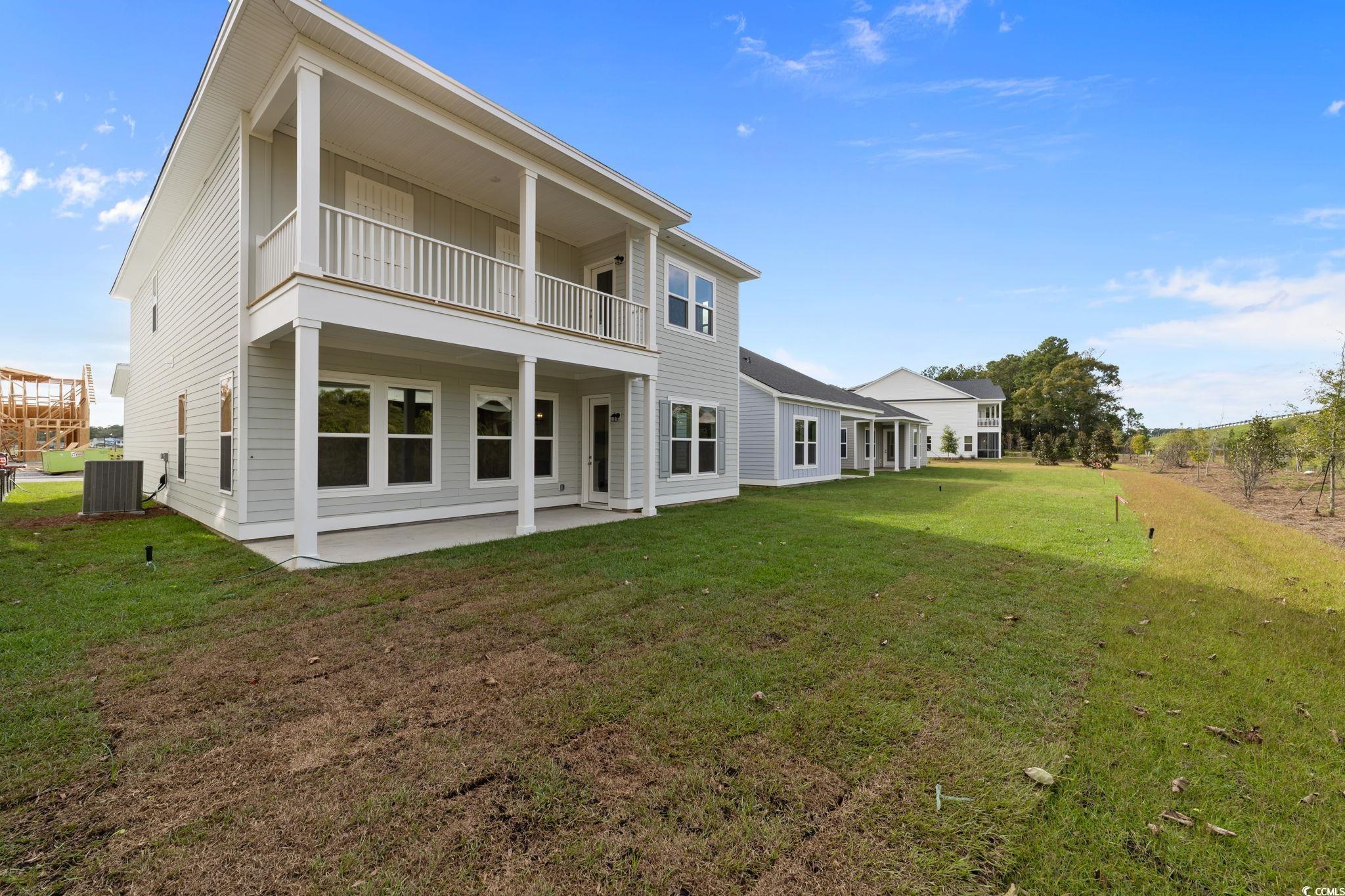 775 Ebb Tide Road Little River, SC 29566 - Photo 6 of 39 Rear view of property featuring a patio, a yard, and a balcony