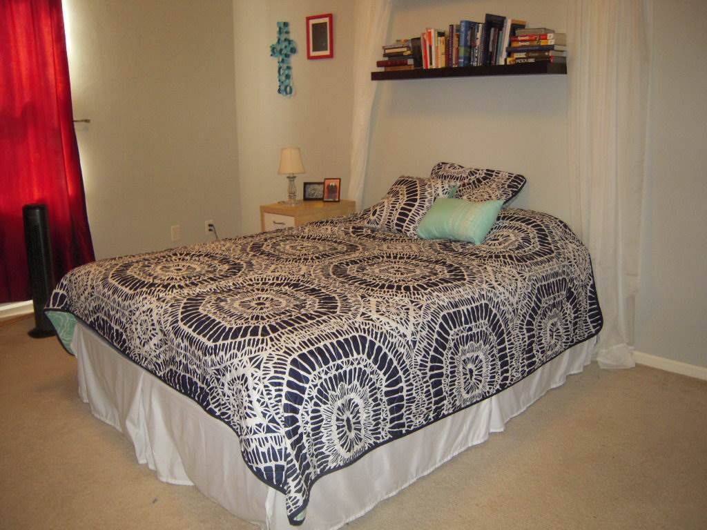 10138 Monarch Road, Unit 2 Roscoe, IL 61073 - Photo 10 of 16 a bed sitting in a bedroom next to a window and storage
