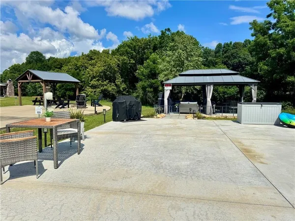 a view of a patio with a table and chairs under an umbrella