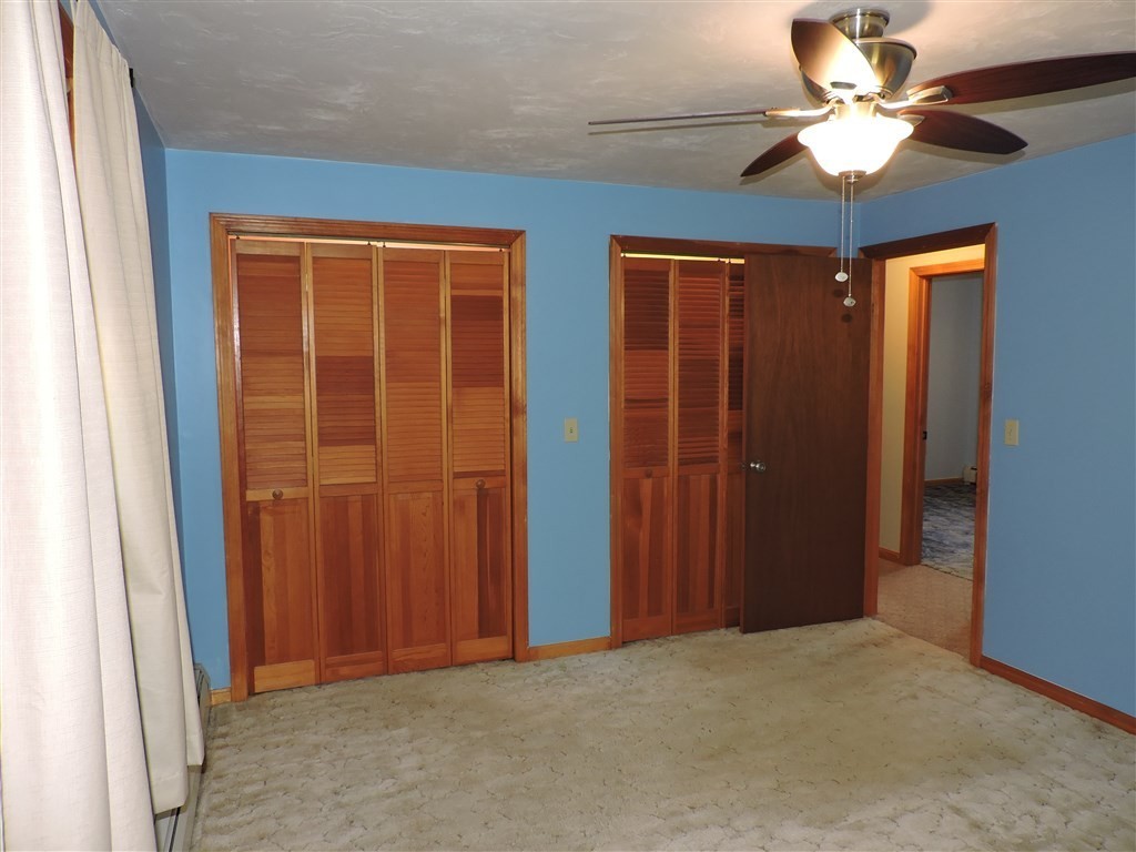 15 Lower Gore Road Webster, MA 01570 - Photo 18 of 30 an empty room with closet and a chandelier fan