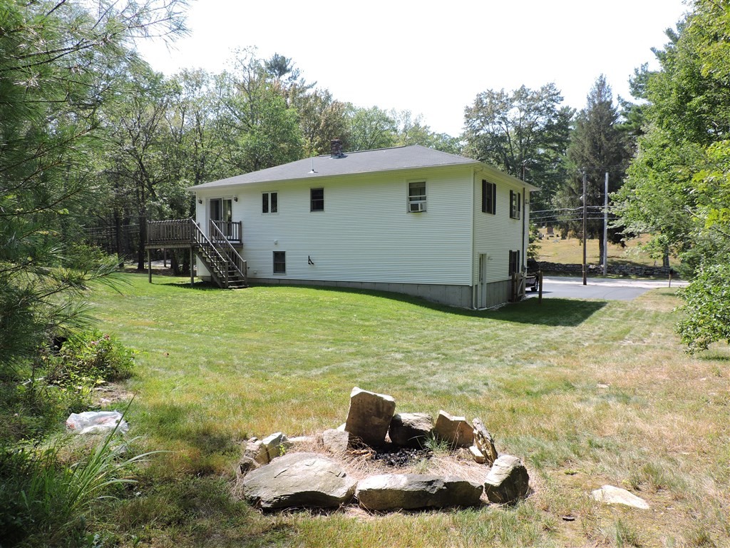 15 Lower Gore Road Webster, MA 01570 - Photo 3 of 30 a backyard of a house with yard and barbeque oven
