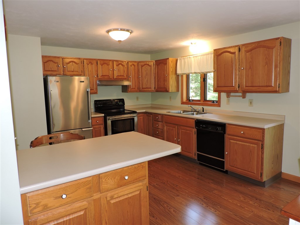 15 Lower Gore Road Webster, MA 01570 - Photo 5 of 30 a kitchen with a sink a stove a refrigerator a center island and cabinets
