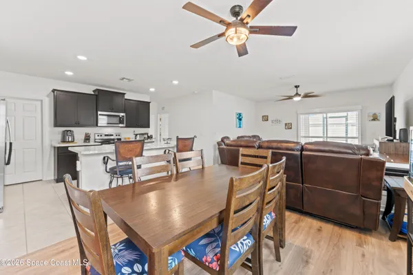 a kitchen with kitchen island a appliances dining table and chairs