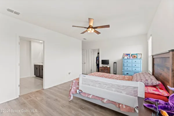 a bedroom with a bed and a desk