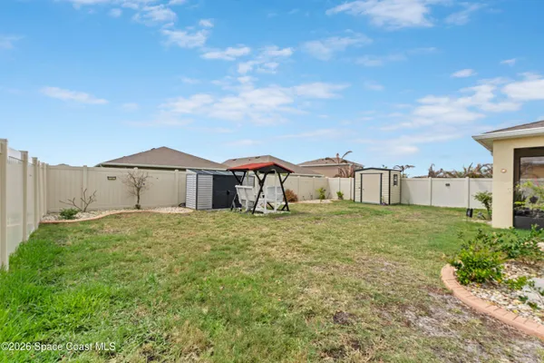an aerial view of a house with a garden and lake view