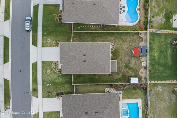an aerial view of residential houses with outdoor space
