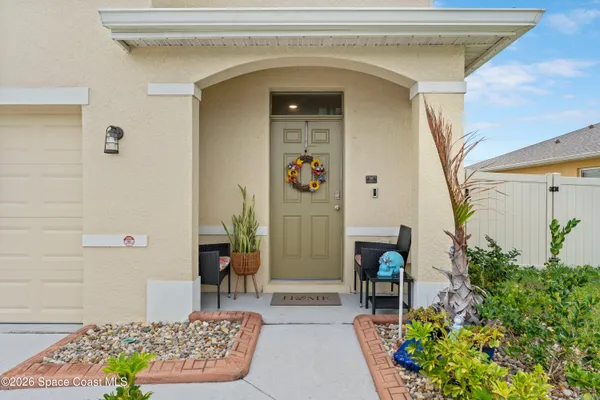 a living room with furniture a flat screen tv and kitchen view