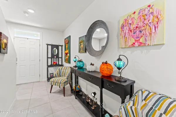 a living room with couches and a ceiling fan