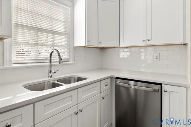 a kitchen with sink and cabinets