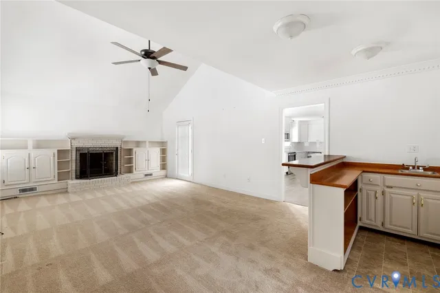 a view of a kitchen with a sink and dishwasher a stove top oven with wooden floor