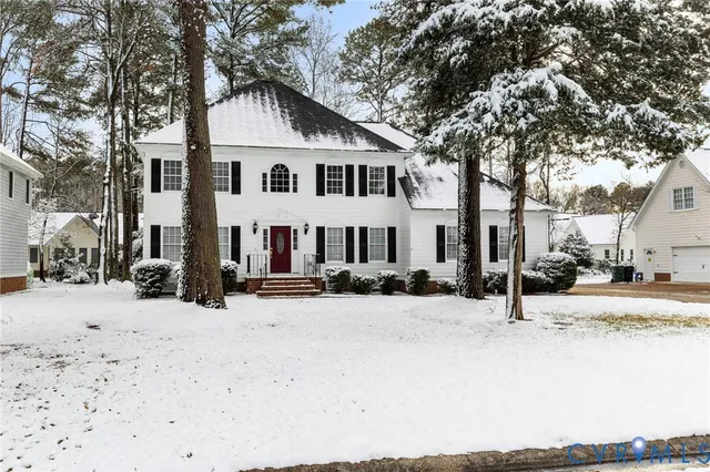 a view of a house with a snow in the yard