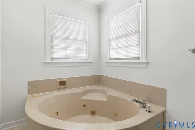 a white bath tub sitting next to a window