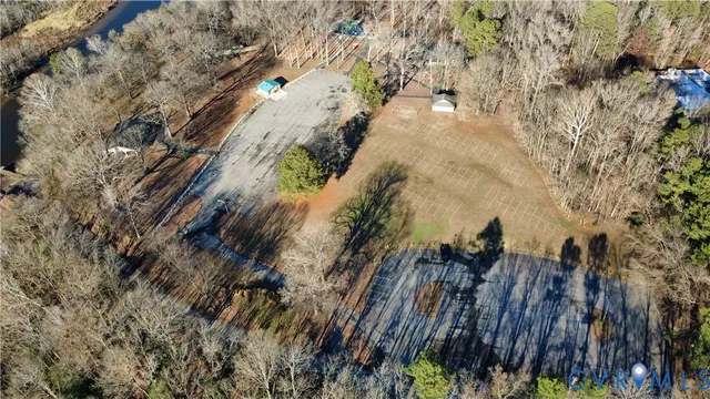 a view of a swimming pool with a patio and a yard