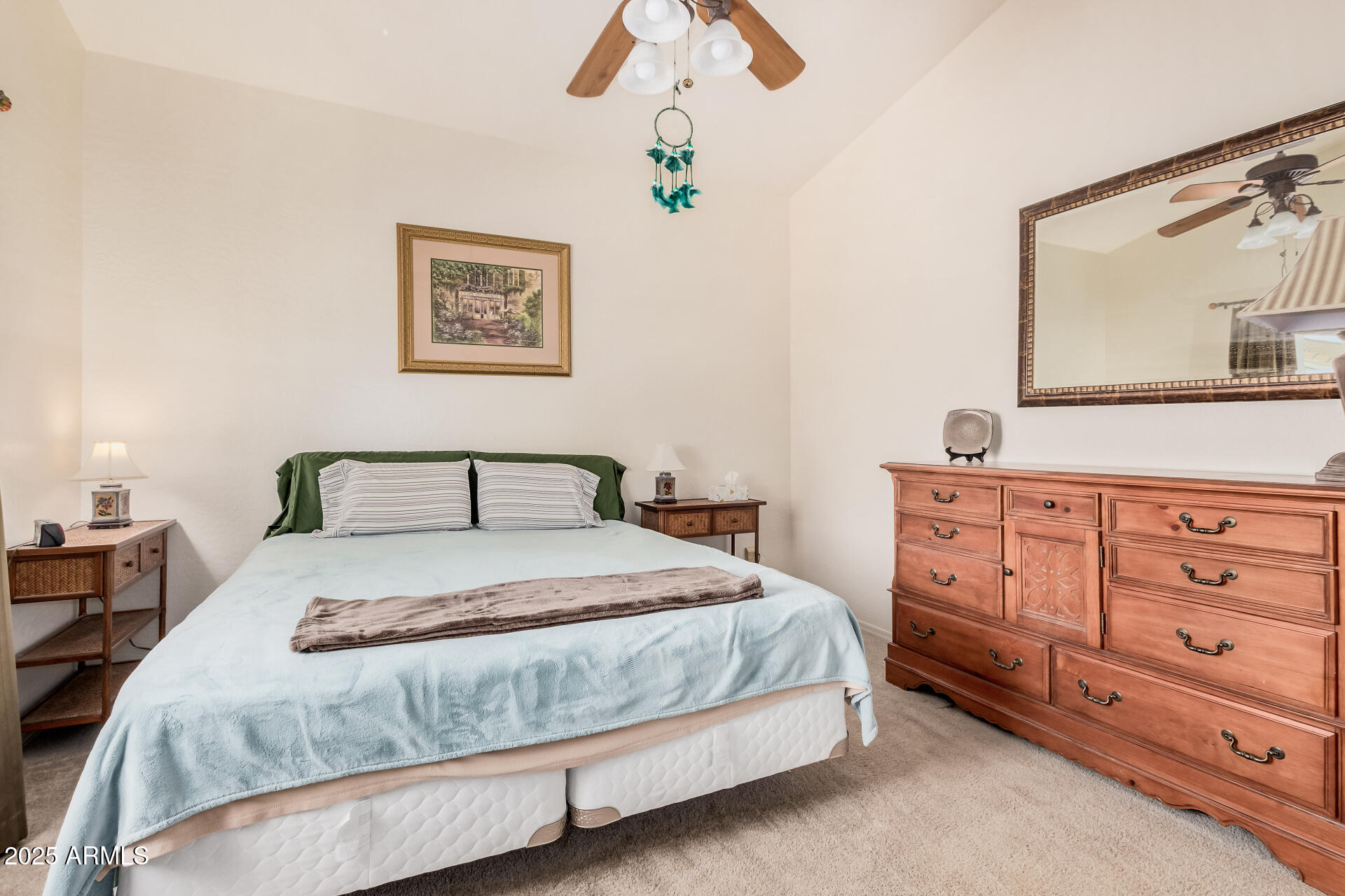 2496 West Tanner Ranch Road San Tan Valley, AZ 85144 - Photo 10 of 25 a bedroom with a bed a lamp and a large mirror