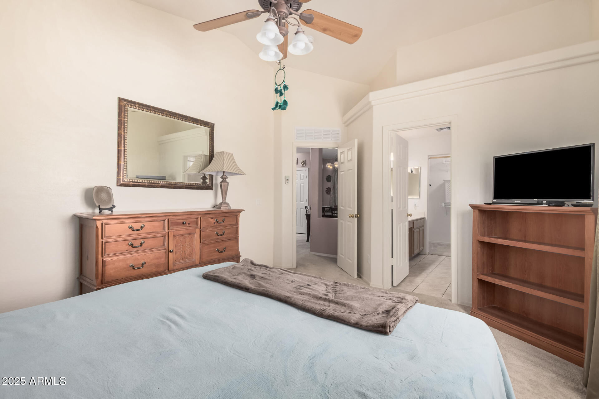 2496 West Tanner Ranch Road San Tan Valley, AZ 85144 - Photo 11 of 25 a bedroom with a bed and a flat screen tv