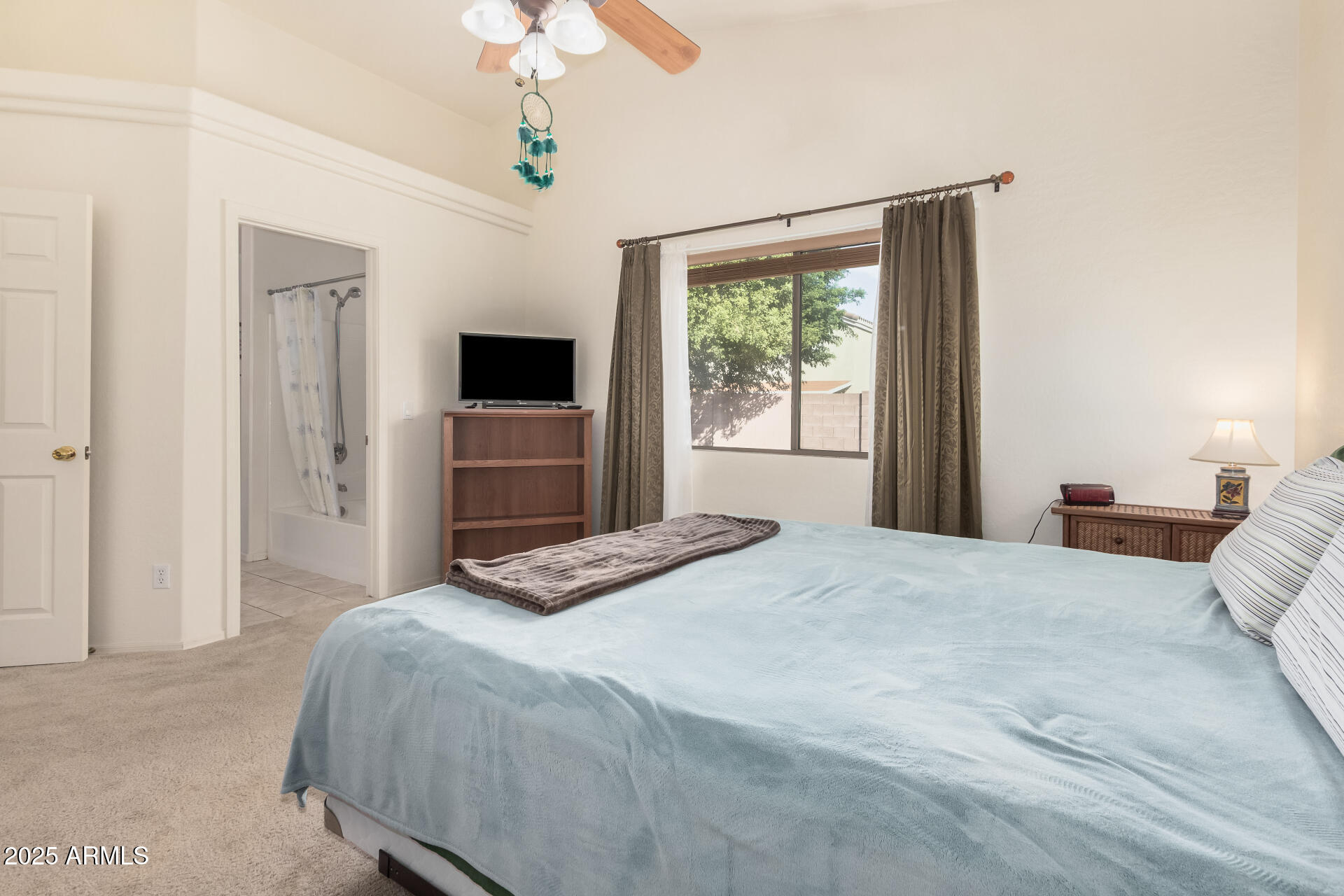 2496 West Tanner Ranch Road San Tan Valley, AZ 85144 - Photo 12 of 25 a bedroom with a bed and a flat tv screen