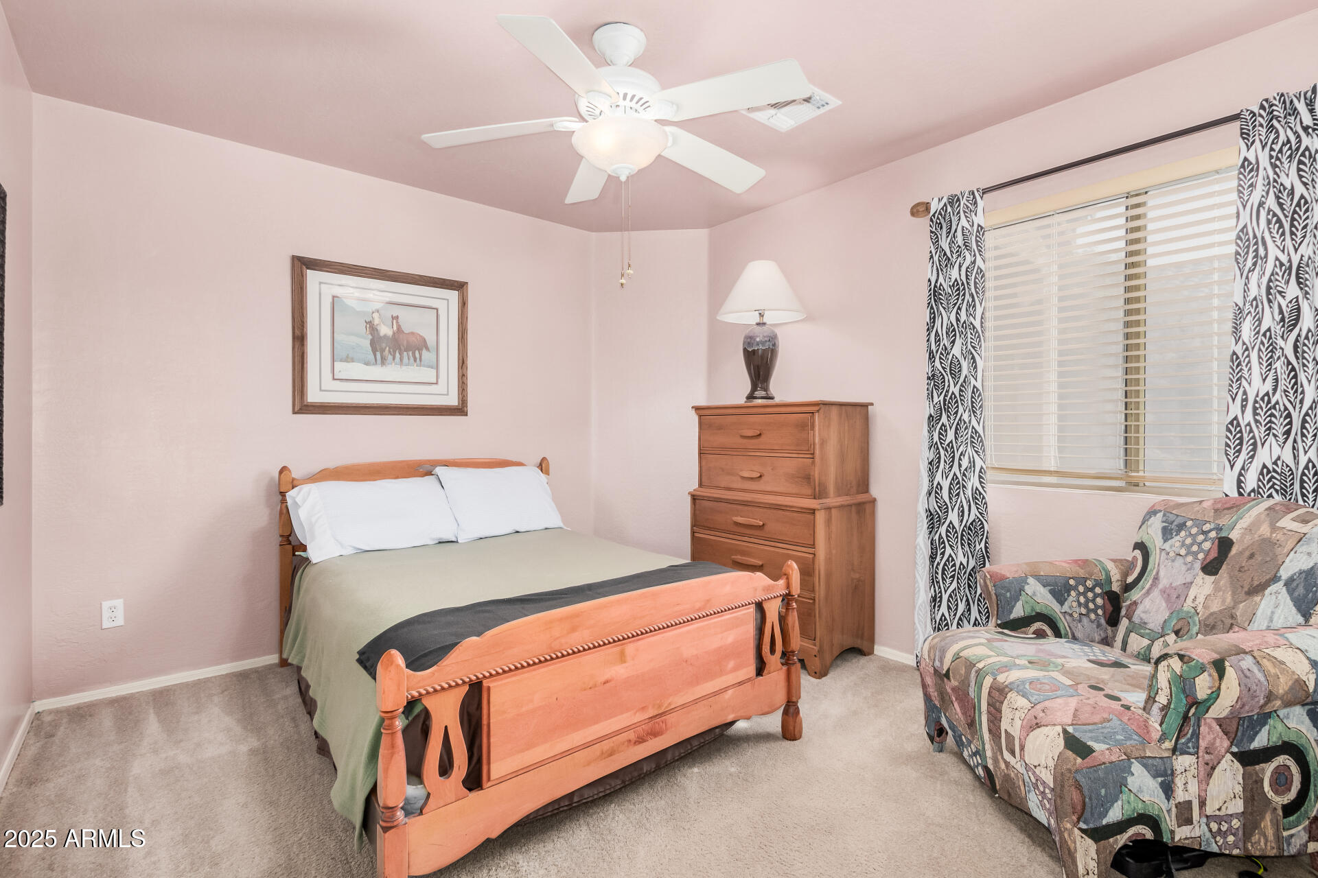 2496 West Tanner Ranch Road San Tan Valley, AZ 85144 - Photo 14 of 25 a bedroom with a bed and a chandelier