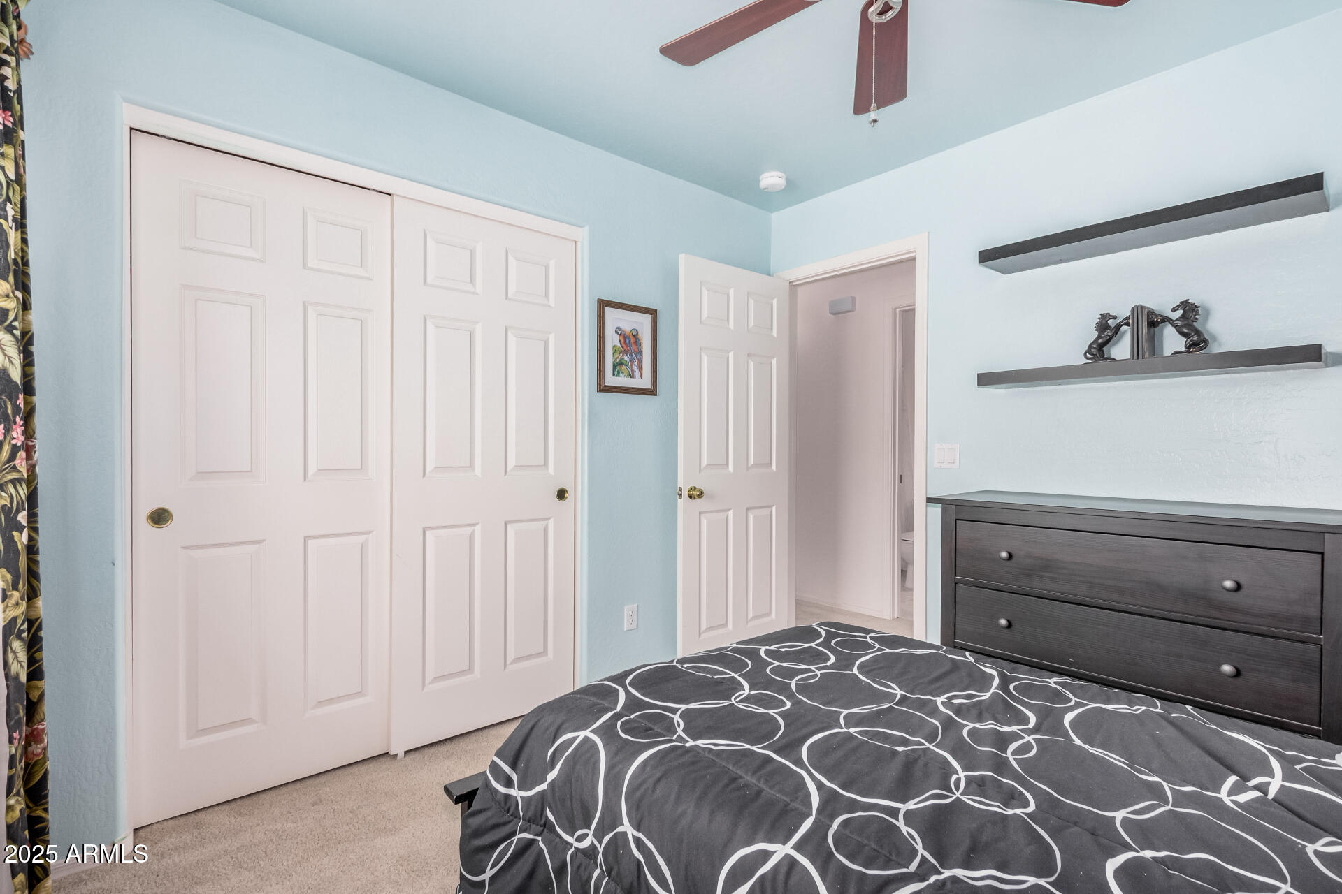 2496 West Tanner Ranch Road San Tan Valley, AZ 85144 - Photo 17 of 25 a bedroom with a bed and a cabinet
