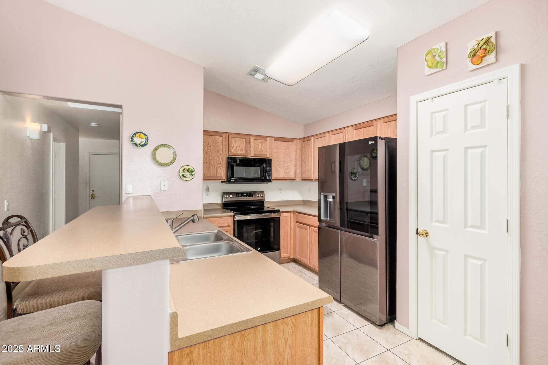 2496 West Tanner Ranch Road San Tan Valley, AZ 85144 - Photo 8 of 25 a kitchen with a refrigerator and a sink