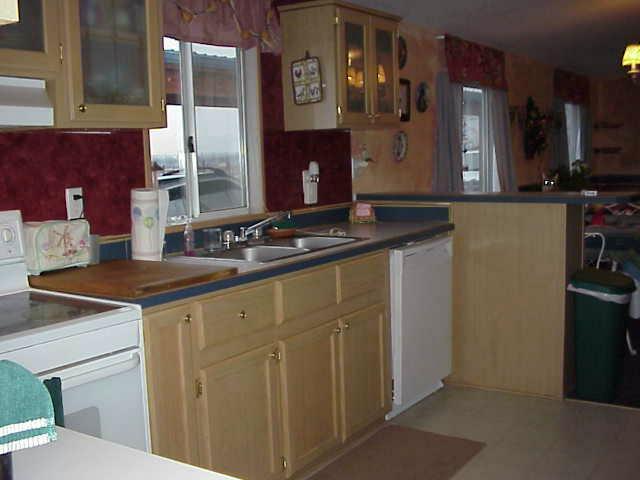 6414 Postma Road Yakima, WA 98901 - Photo 4 of 9 a kitchen with stainless steel appliances granite countertop a sink and a refrigerator