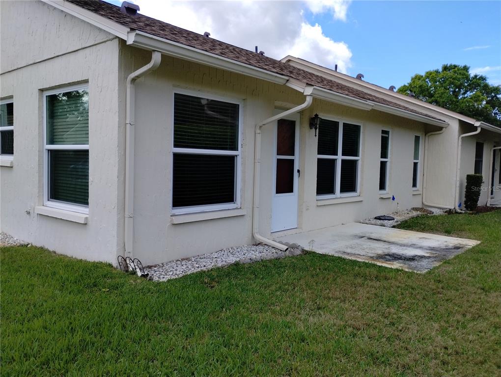11543 Orleans Lane, Unit B Port Richey, FL 34668 - Photo 11 of 11 a view of a house with garden