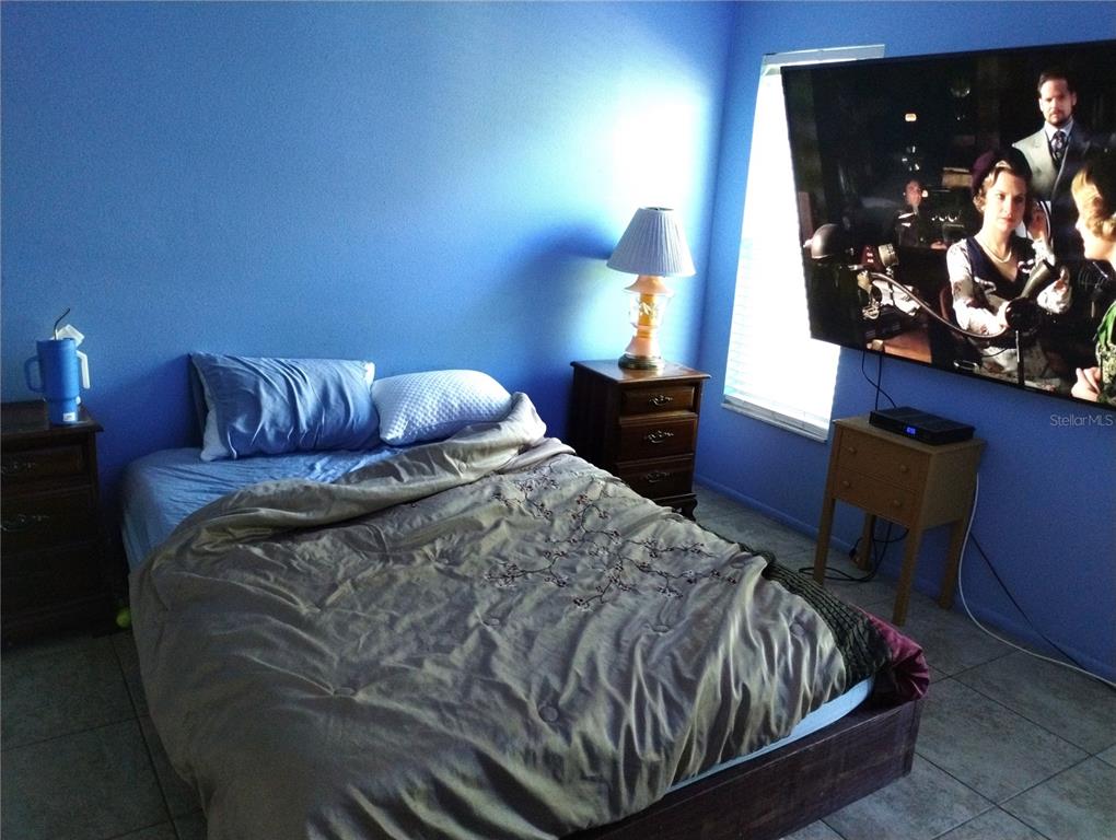 11543 Orleans Lane, Unit B Port Richey, FL 34668 - Photo 6 of 11 a bedroom with a bed and dresser