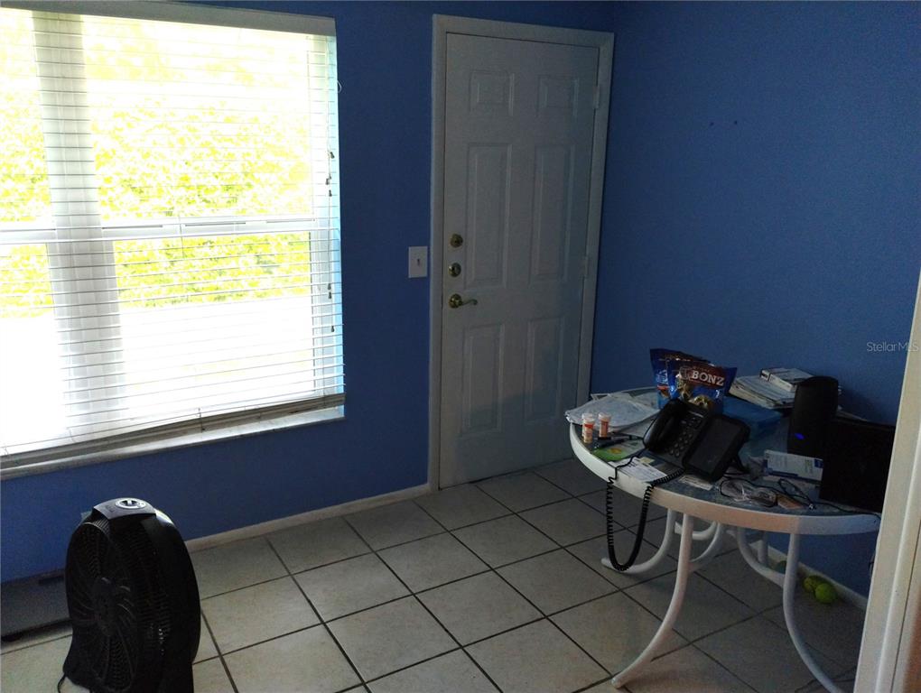 11543 Orleans Lane, Unit B Port Richey, FL 34668 - Photo 8 of 11 a living room with a chair and a window