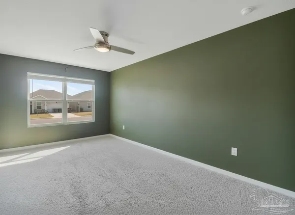 a view of a livingroom with a ceiling fan and window